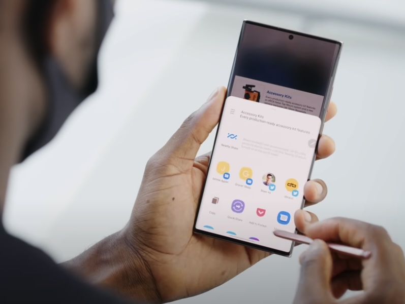 Man using phone with stylus